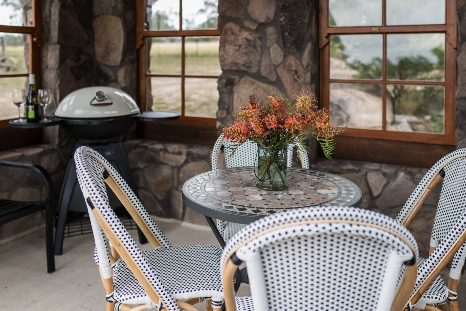 Inside the gazebo &mdash; barbecue, table and chairs out of the weather