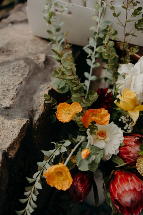 A native bridal bouquet resting on a timber bar in afternoon light